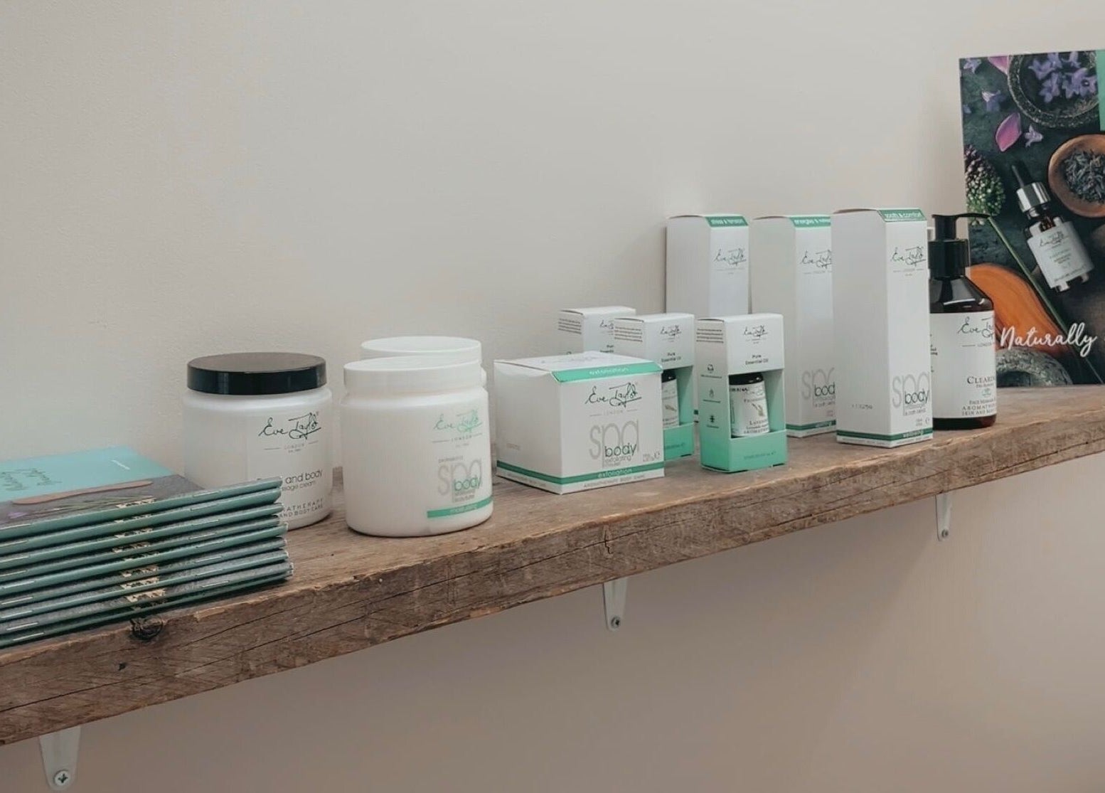 Beauty products on a wooden shelf at The Hive Beauty, Holistics & Hair in Cullompton, England, GB.