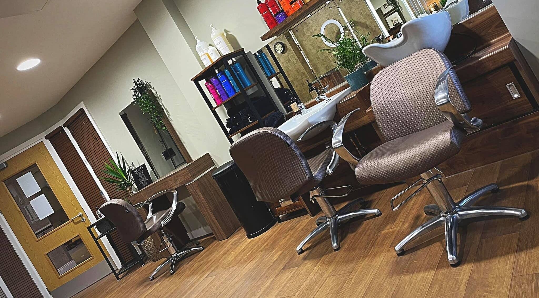 Chic interior of Meraki Hair Design in Thorne, England, GB, featuring modern styling chairs and hair care products.