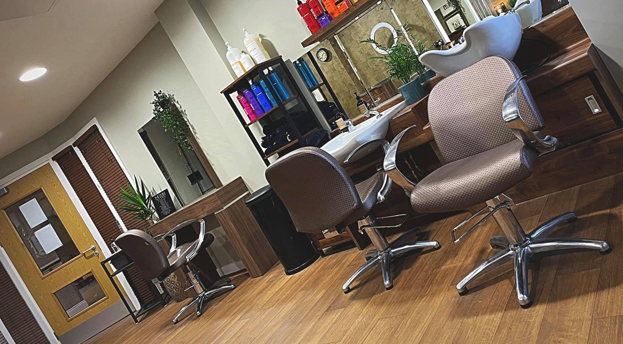 Chic interior of Meraki Hair Design in Thorne, England, GB, featuring modern styling chairs and hair care products.