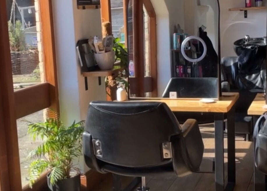 Bright and modern salon chairs at Bavaro’s Hair Design Ltd, Aldwincle, England, GB, beautifully lit by sunlight.