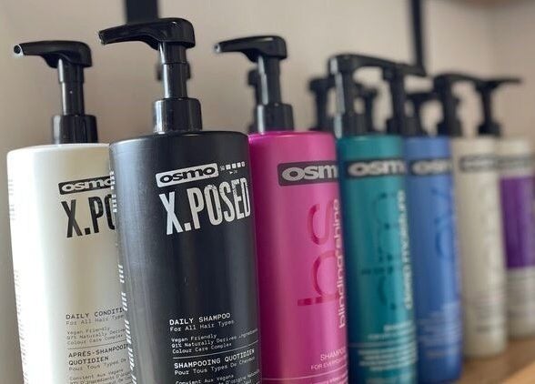 A vibrant row of shampoo bottles at Bavaro’s Hair Design Ltd, Aldwincle, England, GB.