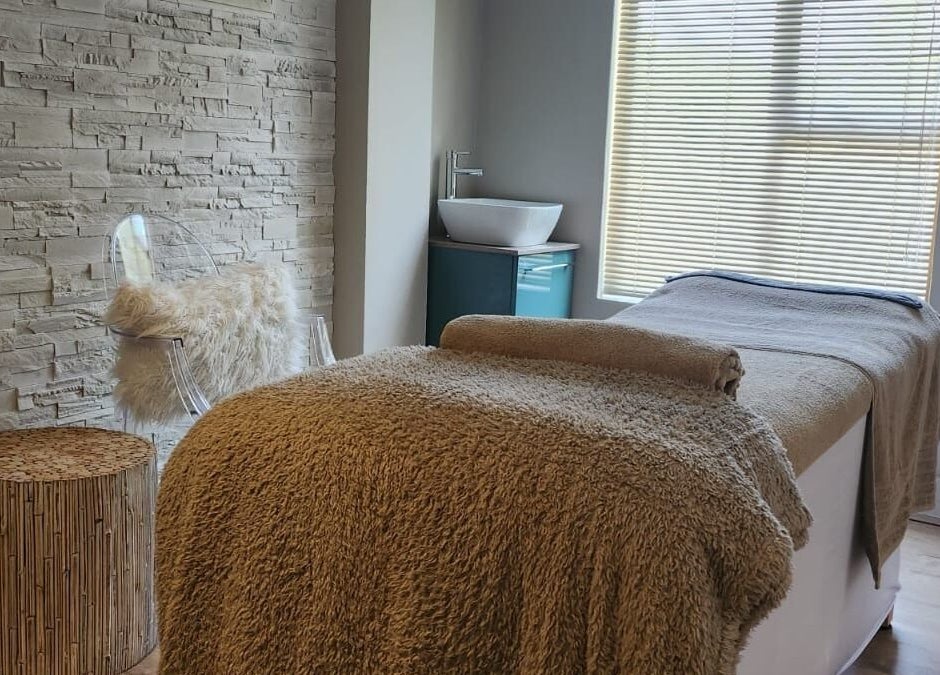 Relaxing treatment room at The Skin Revision Co, Centurion, Gauteng, ZA, with plush blanket and elegant decor.