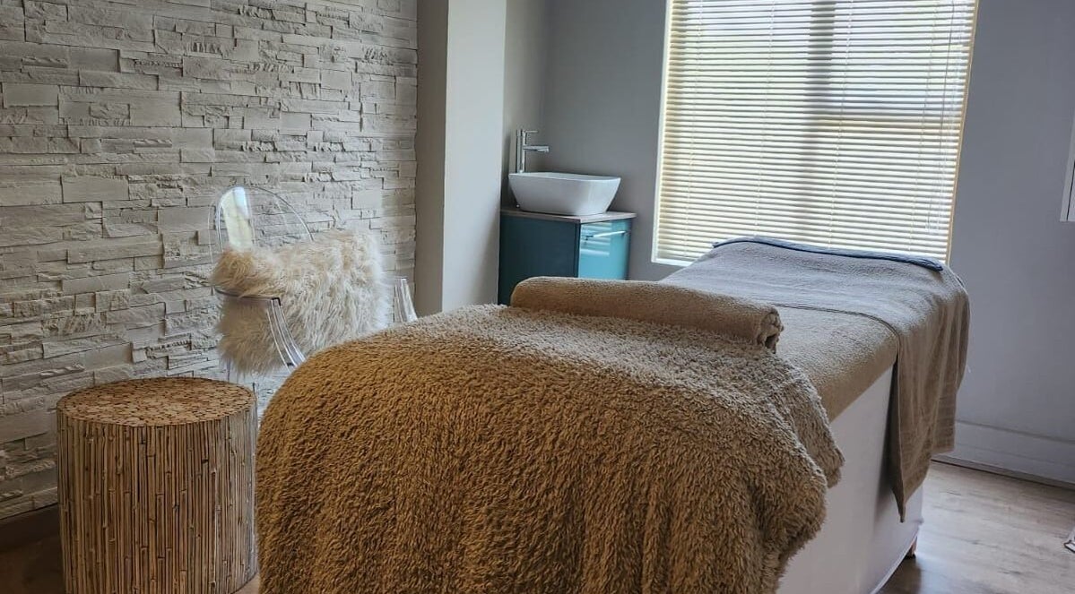 Relaxing treatment room at The Skin Revision Co, Centurion, Gauteng, ZA, with plush blanket and elegant decor.