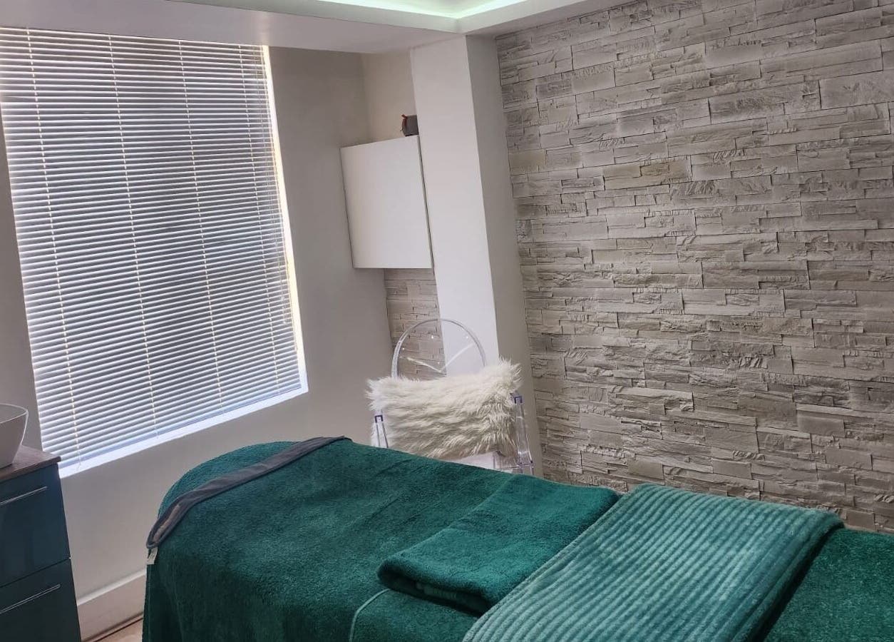 Tranquil treatment room at The Skin Revision Co, Centurion, Gauteng, ZA with a plush spa bed and textured walls.