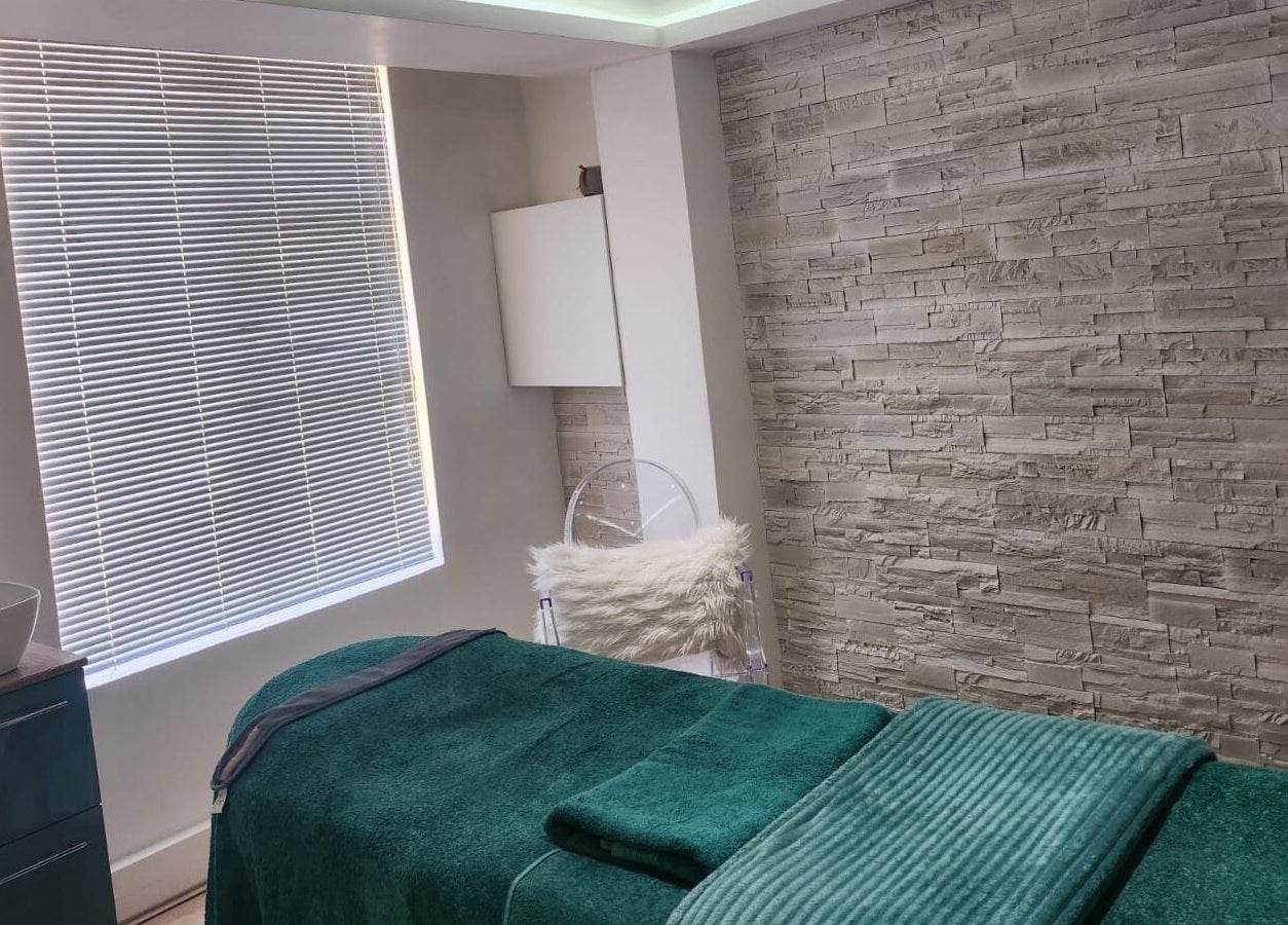 Tranquil treatment room at The Skin Revision Co, Centurion, Gauteng, ZA with a plush spa bed and textured walls.