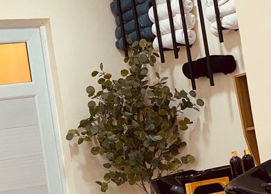 Relaxing corner at Ignite Beauty and Luxury Salon, Lagos, Lagos, NG with towels and a plant.