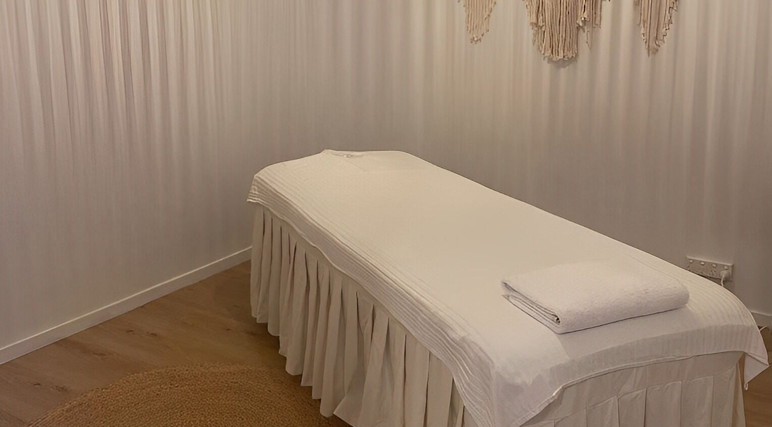 Tranquil massage room at Relaxology Massage Takapuna in Auckland, Auckland, NZ, featuring a cozy bed.
