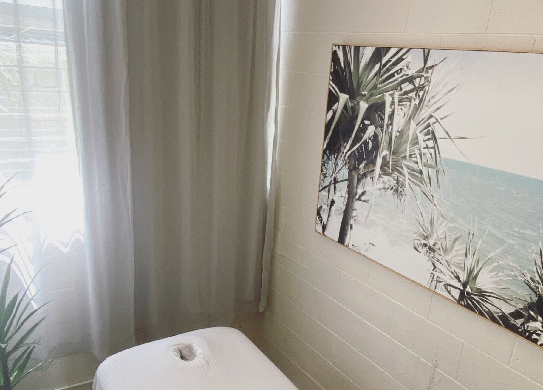 Tranquil massage room at Relaxology Massage Takapuna, Auckland, NZ with calming beach decor.