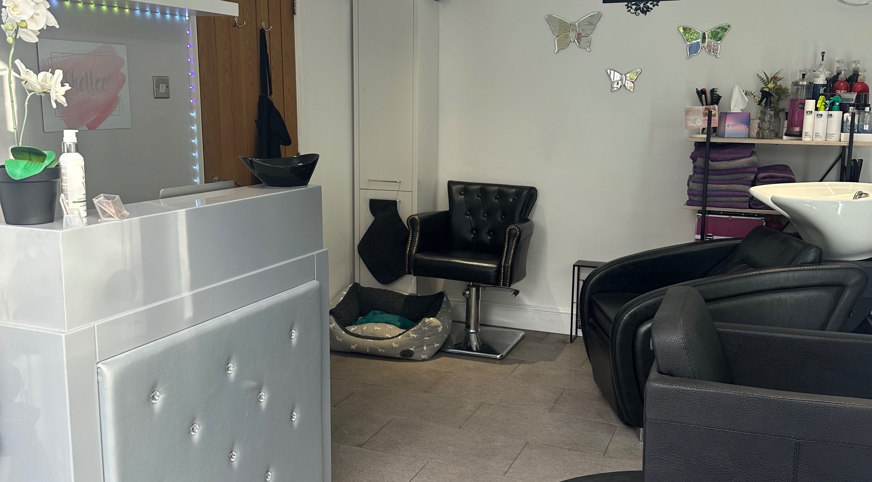 Elegant interior of Shellee at Salon 31 in Hempstead, England, GB features sleek chairs and vibrant decor.