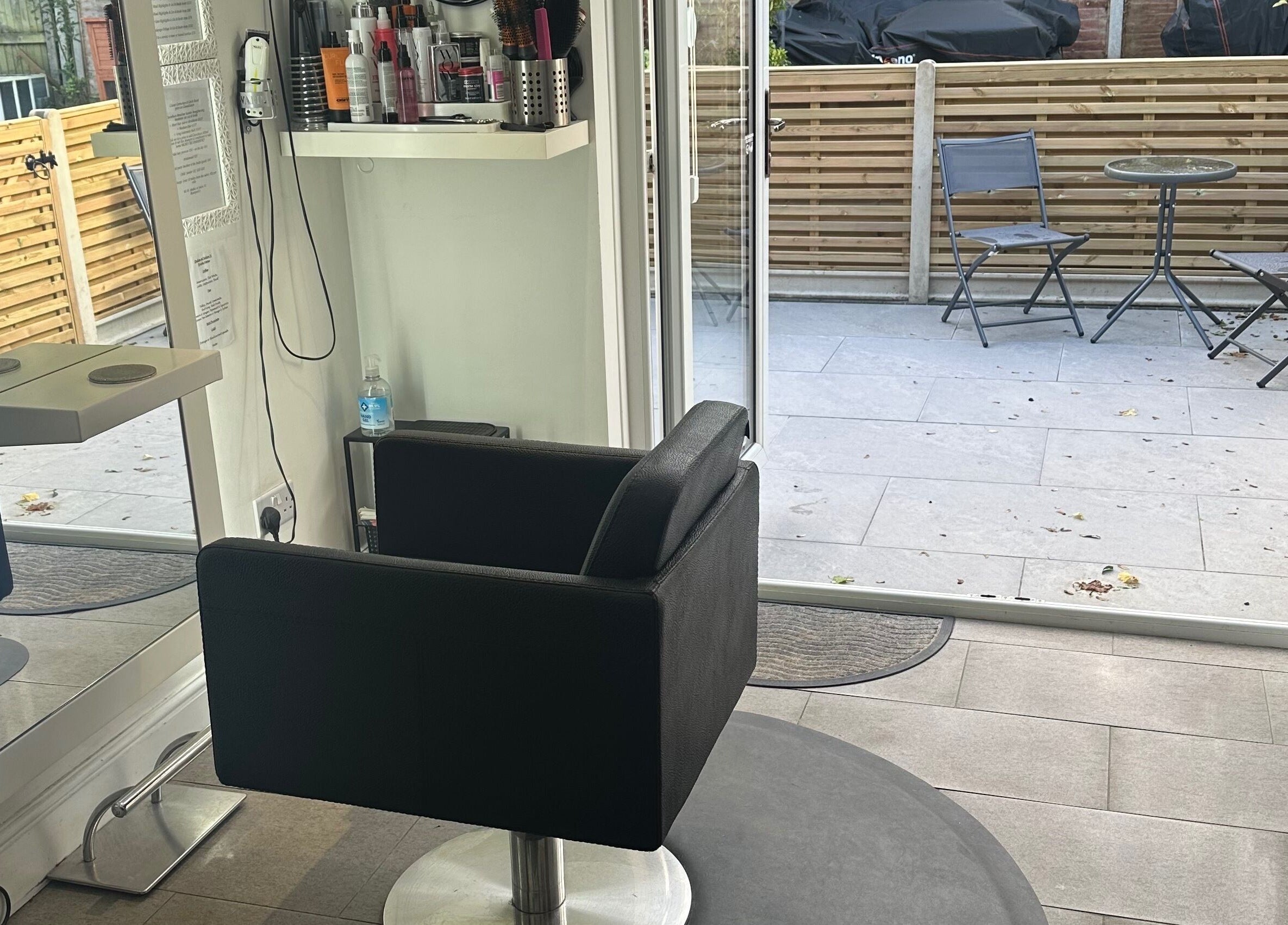 Cozy hair styling chair at Shellee at Salon 31 in Hempstead, England, GB with outdoor view.