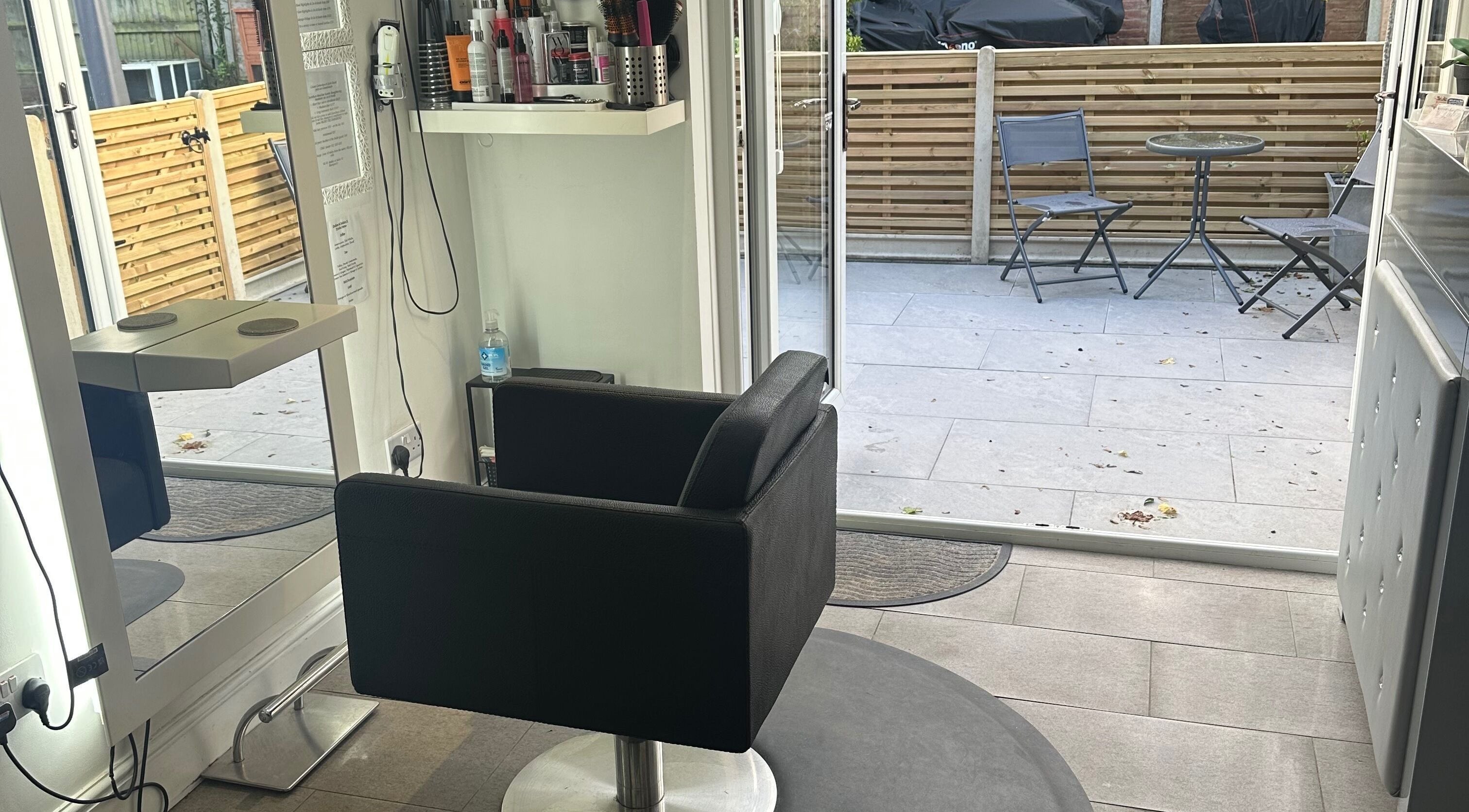 Cozy hair styling chair at Shellee at Salon 31 in Hempstead, England, GB with outdoor view.