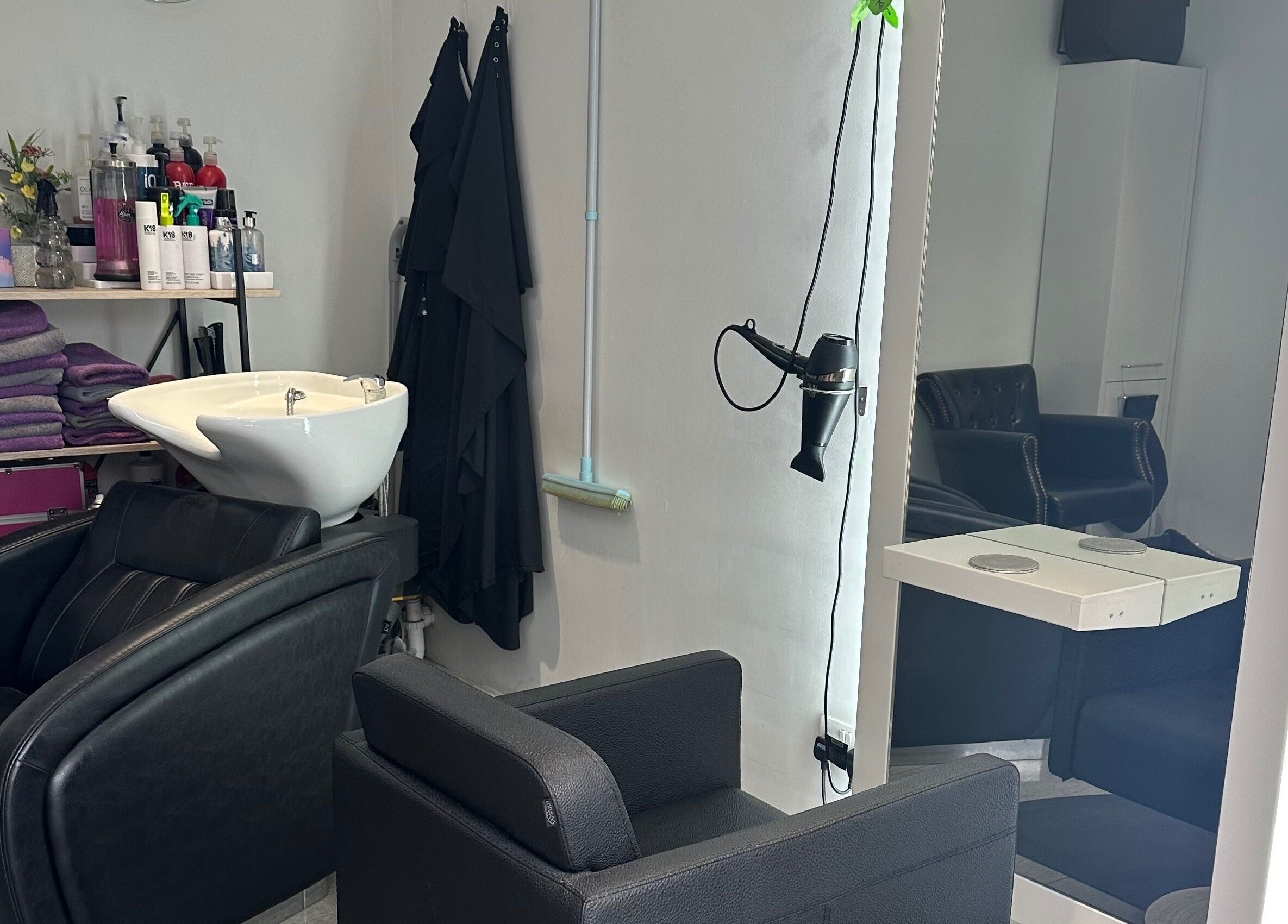 Modern hair salon at Shellee at Salon 31, Hempstead, England, GB, featuring luxurious chairs and hair wash station.