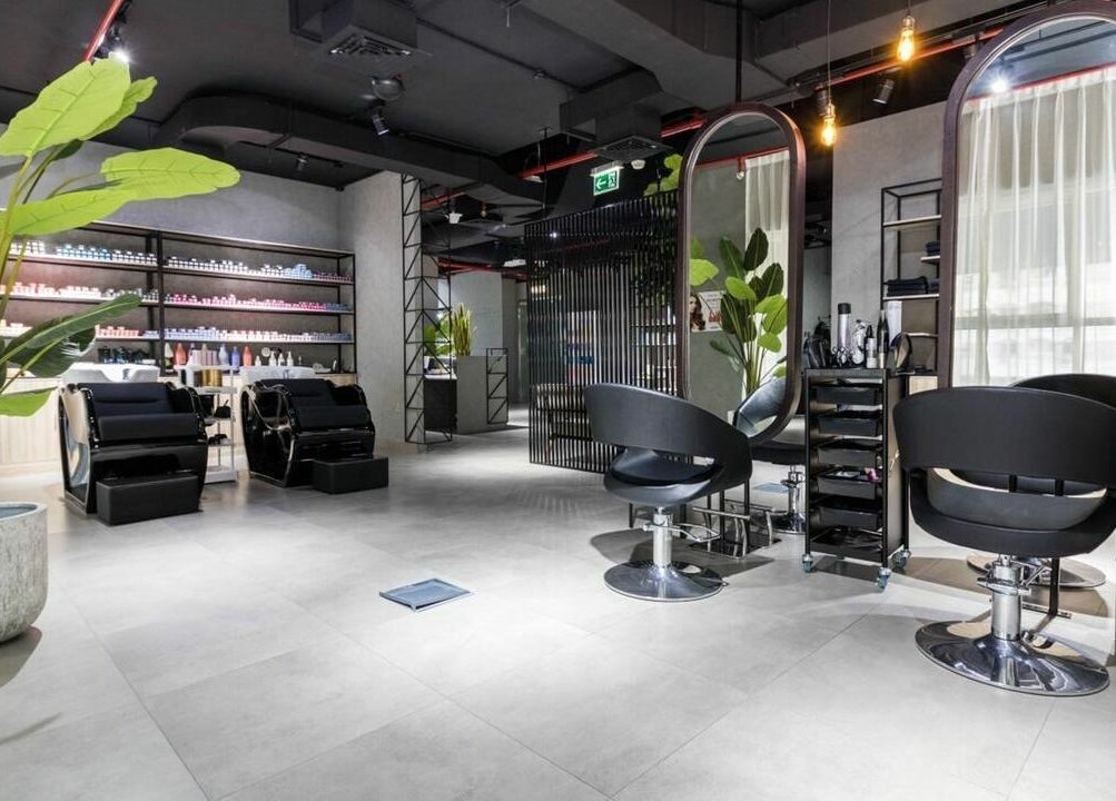 Modern salon at Painted Nails Centre LLC, Abu Dhabi, Abu Dhabi, AE, featuring stylish chairs and lush greenery.