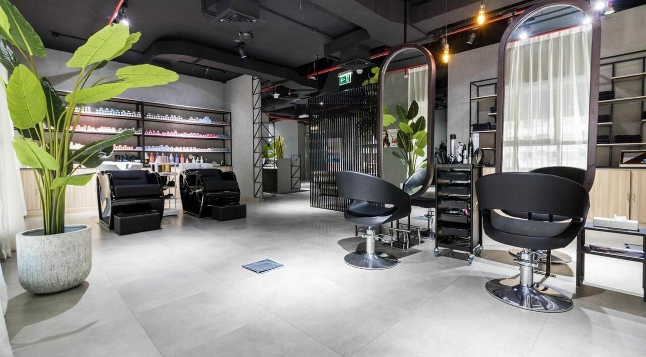 Modern salon at Painted Nails Centre LLC, Abu Dhabi, Abu Dhabi, AE, featuring stylish chairs and lush greenery.