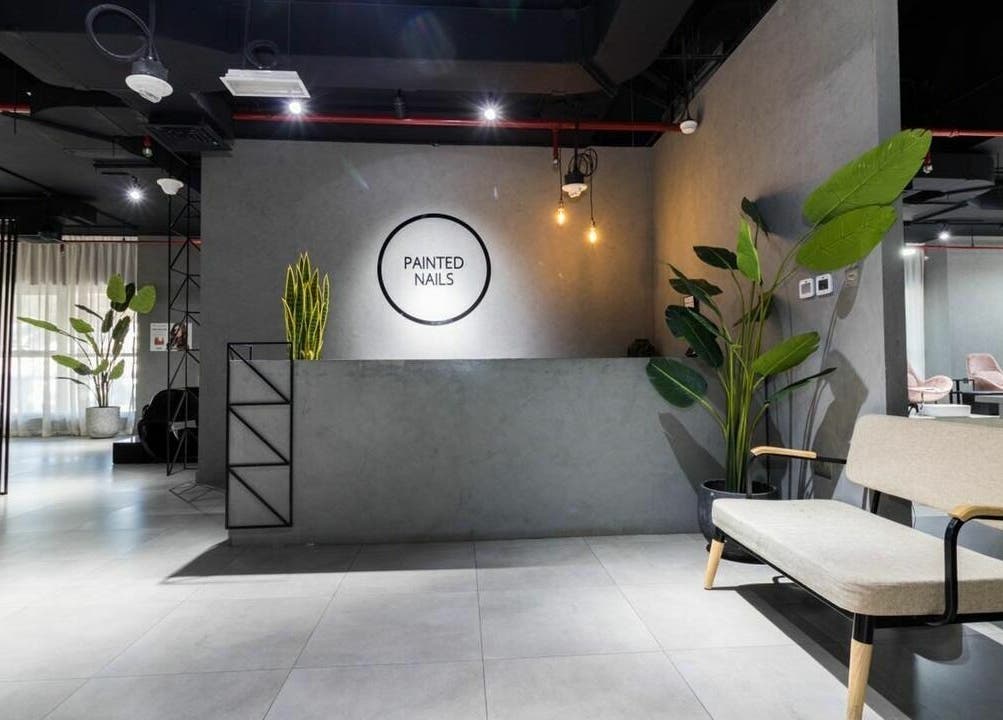 Modern reception area of Painted Nails Centre LLC in Abu Dhabi, AE with sleek decor and lush plants.