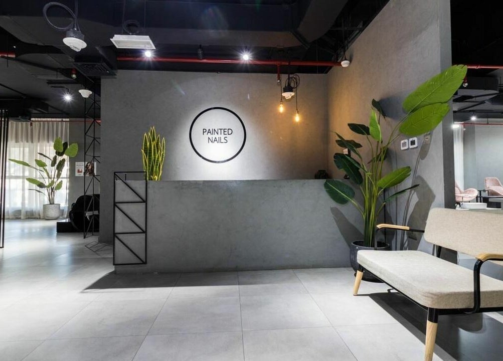 Modern reception area of Painted Nails Centre LLC in Abu Dhabi, AE with sleek decor and lush plants.