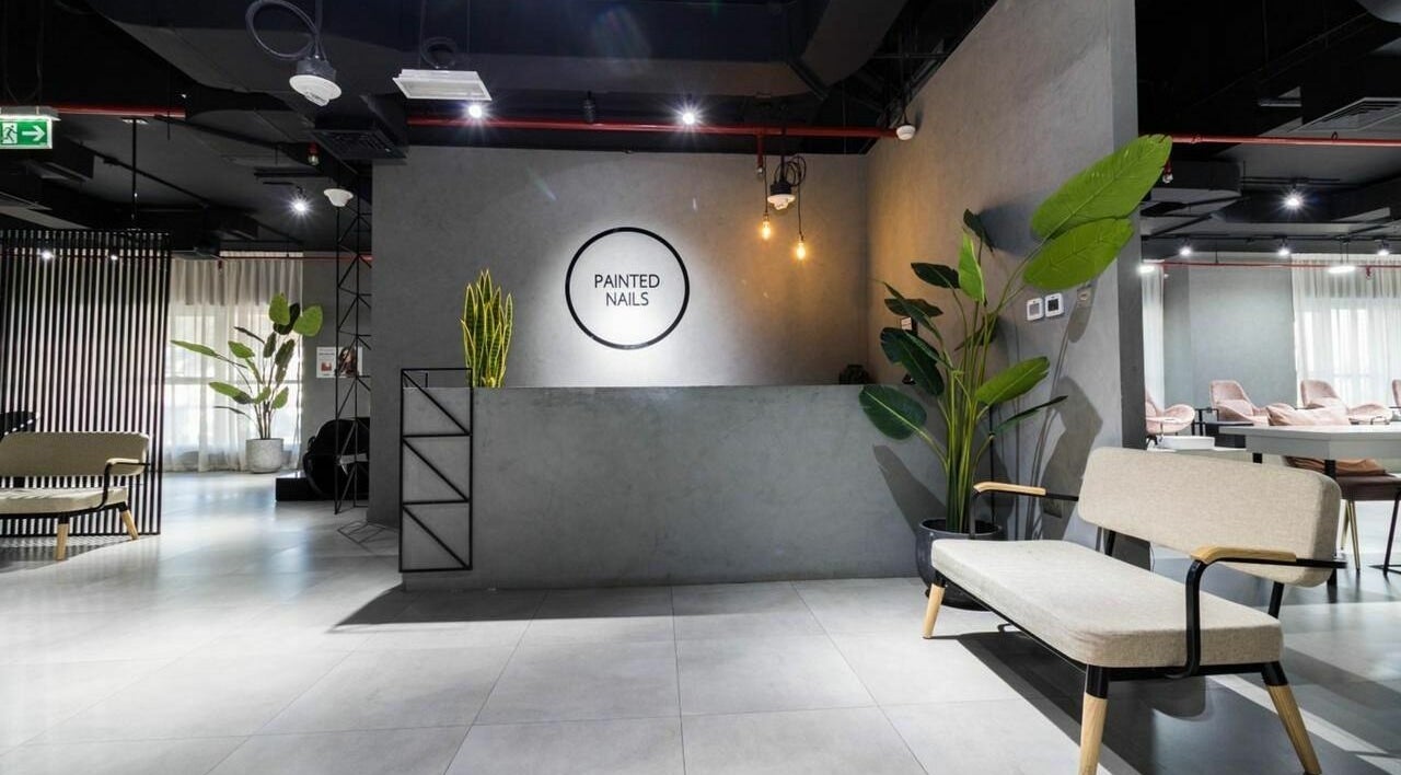 Modern reception area of Painted Nails Centre LLC in Abu Dhabi, AE with sleek decor and lush plants.