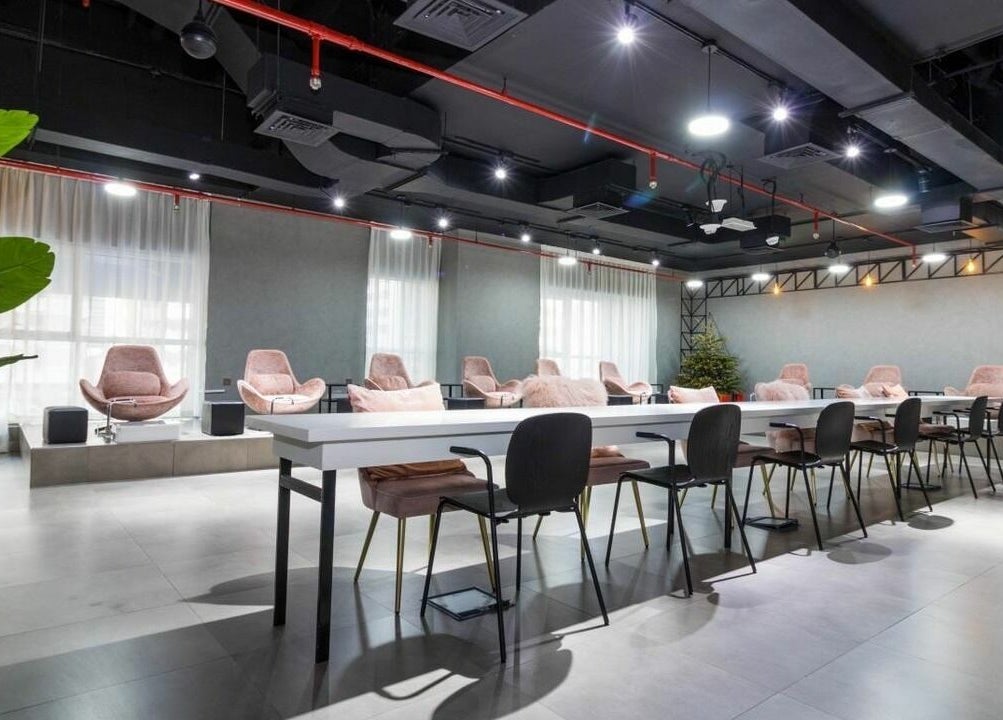 Spacious, modern lounge at Painted Nails Centre LLC, Abu Dhabi, Abu Dhabi, AE with plush seating and bright lighting.