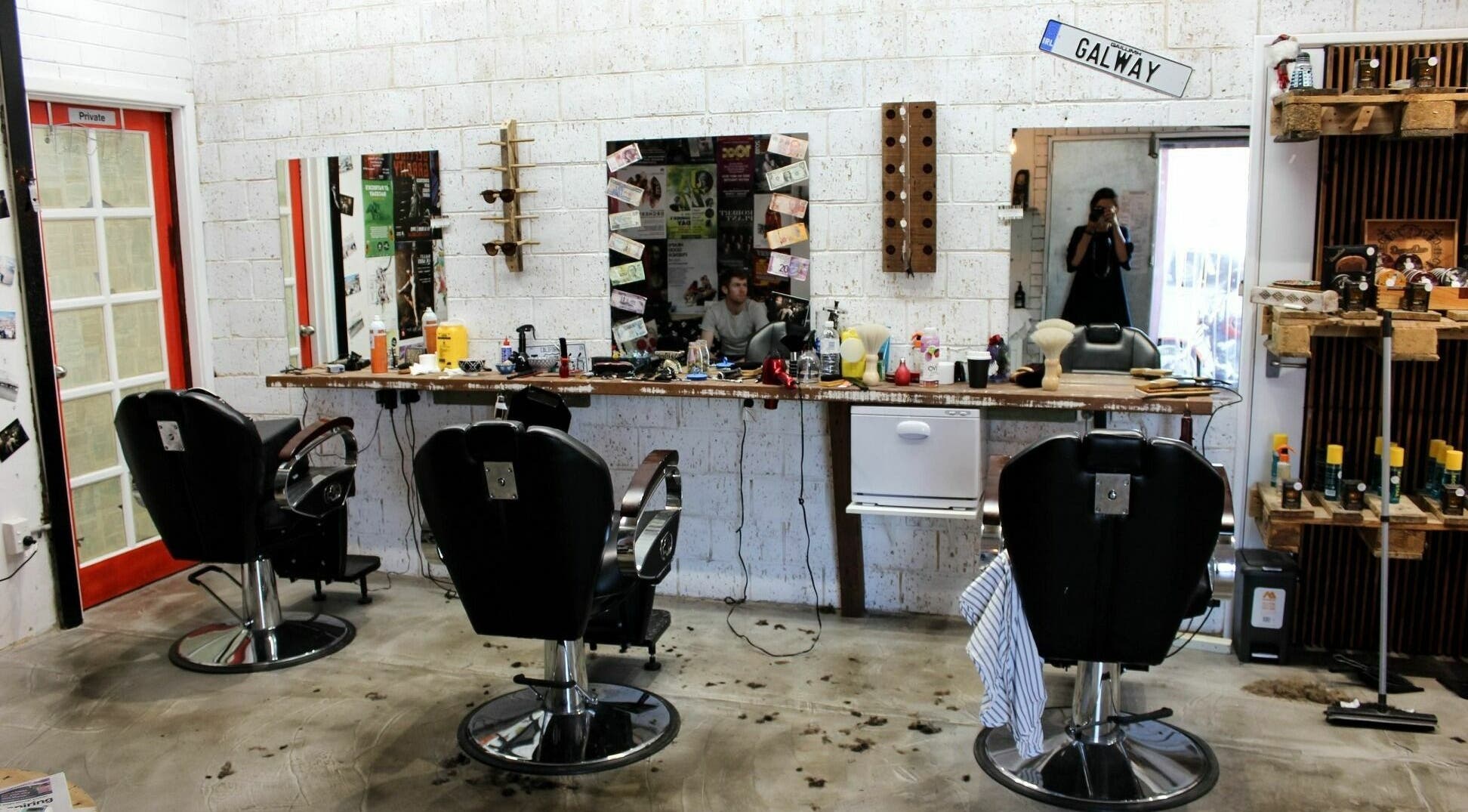 Modern barbershop interior at Scarbra Barbra, Scarborough, Western Australia, AU with stylish decor and chairs.