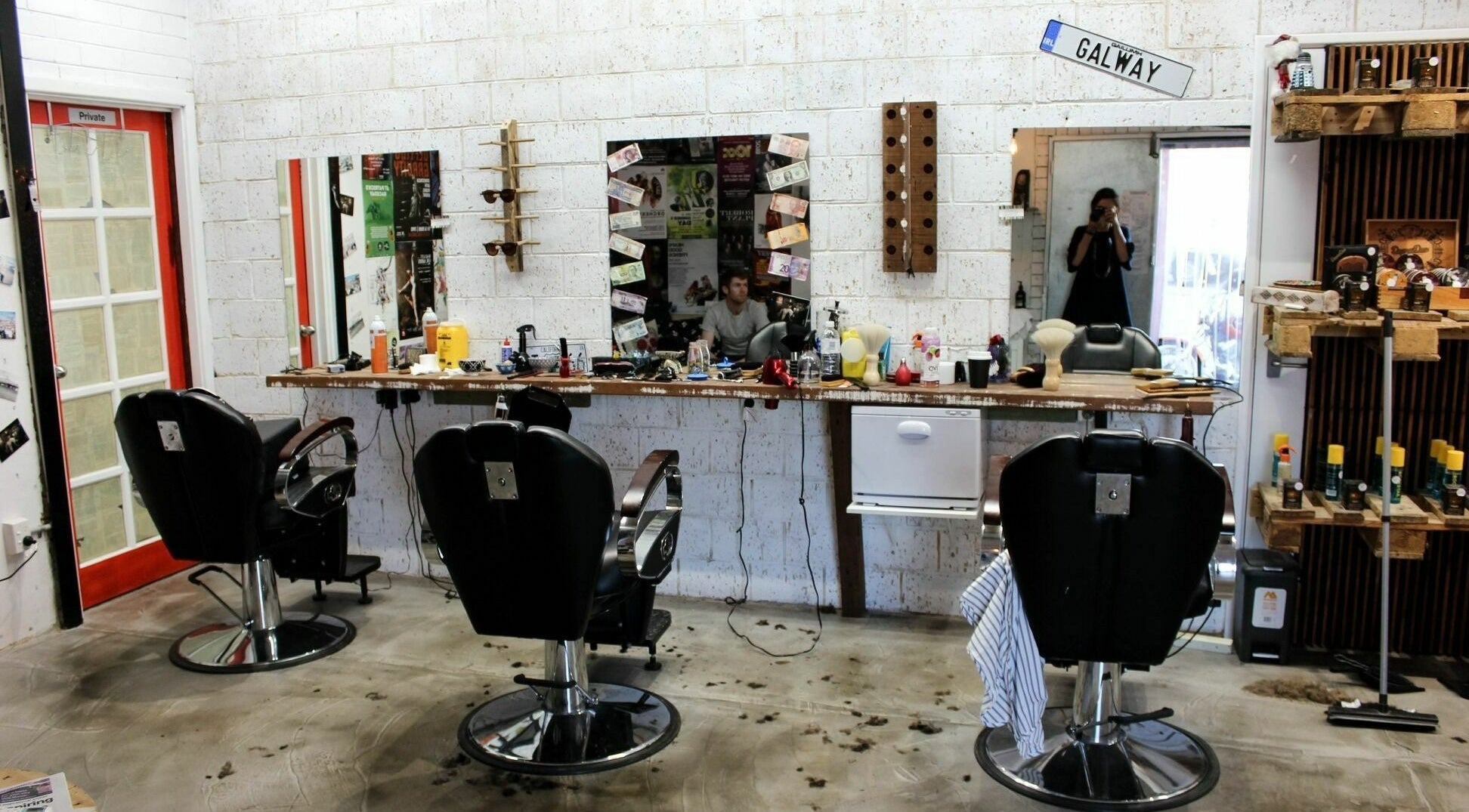 Modern barbershop interior at Scarbra Barbra, Scarborough, Western Australia, AU with stylish decor and chairs.