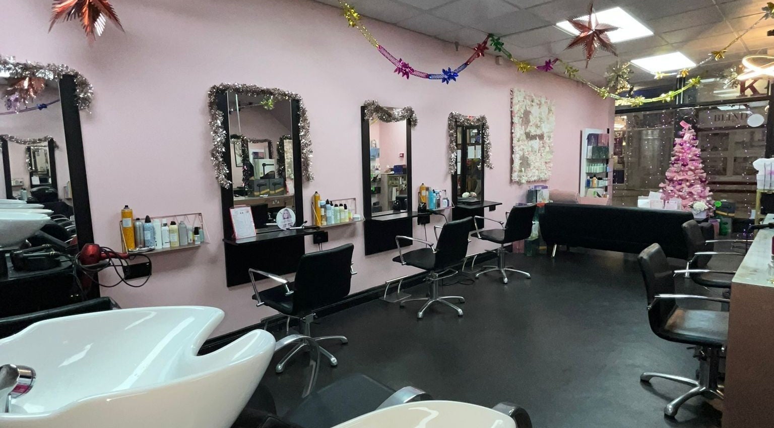 Stylish interior of Monroes Hair and Beauty, Dublin, County Dublin, IE with festive decor and modern salon stations.