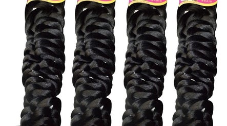 Braiding hair extensions in Noir Braiding Bar, Randburg, Gauteng, ZA offering stylish options.