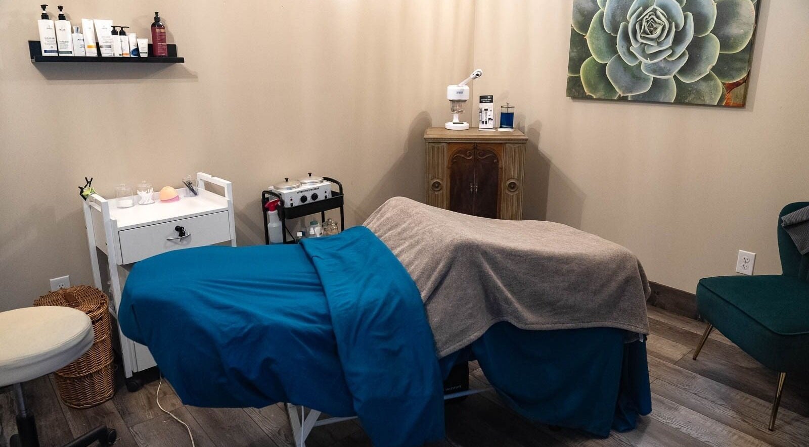 Cozy massage room at In the Spalight, Dickson, Tennessee, US, with a bed and beauty products.