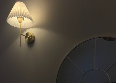 Elegant wall lamp illuminating a mirror at Xtendalash, Mascot, New South Wales, AU creating serene ambiance.