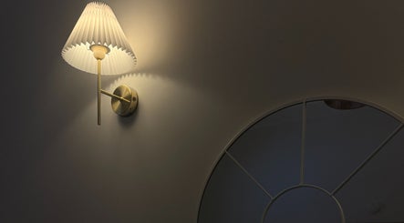 Elegant wall lamp illuminating a mirror at Xtendalash, Mascot, New South Wales, AU creating serene ambiance.