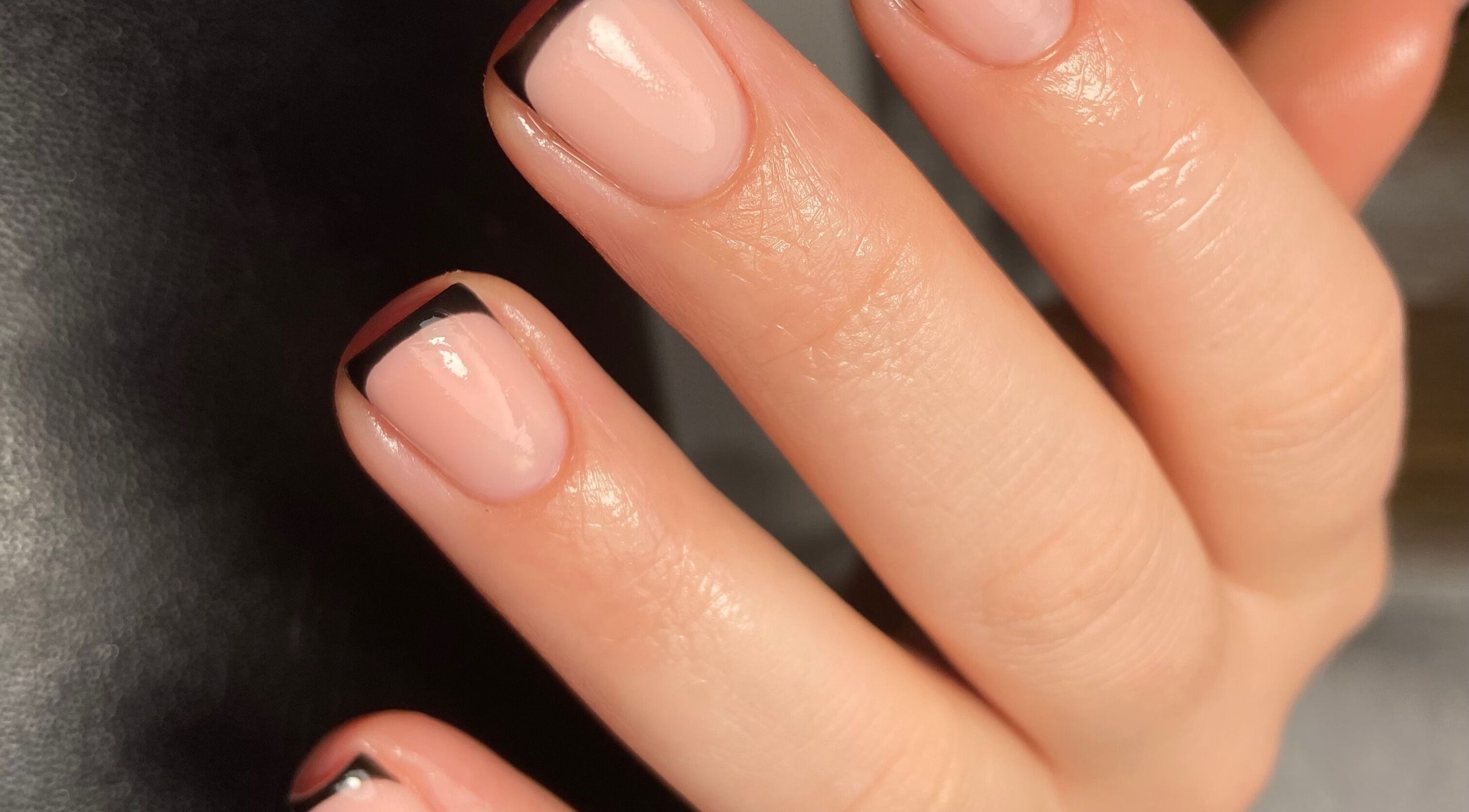 Elegant nails with black French tips at The Beautique Parlour in Portsmouth, England, GB.