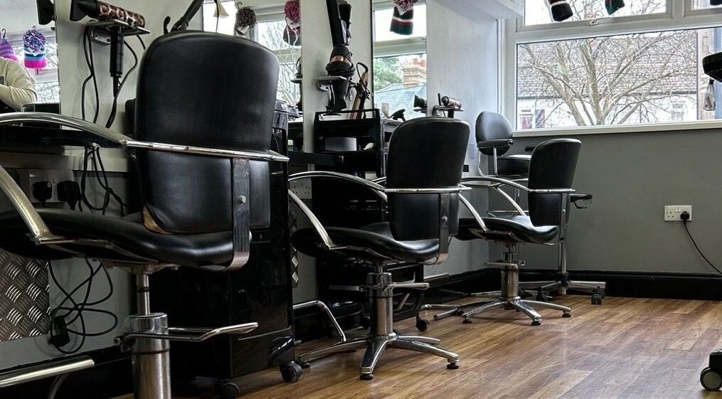 Stylish salon chairs and mirrors at The Salon on the Green, High Wycombe, England, GB.