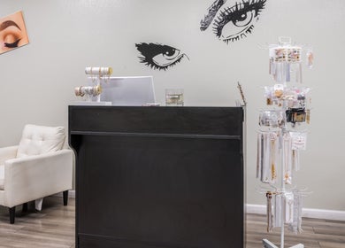 Reception area with decor at Eye Bar Beauty Salon, Stockton, California, US showcasing modern elegance.