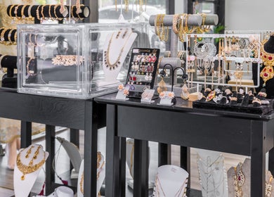 Elegant jewelry display at Eye Bar Beauty Salon, Stockton, California, US, showcasing necklaces and earrings.