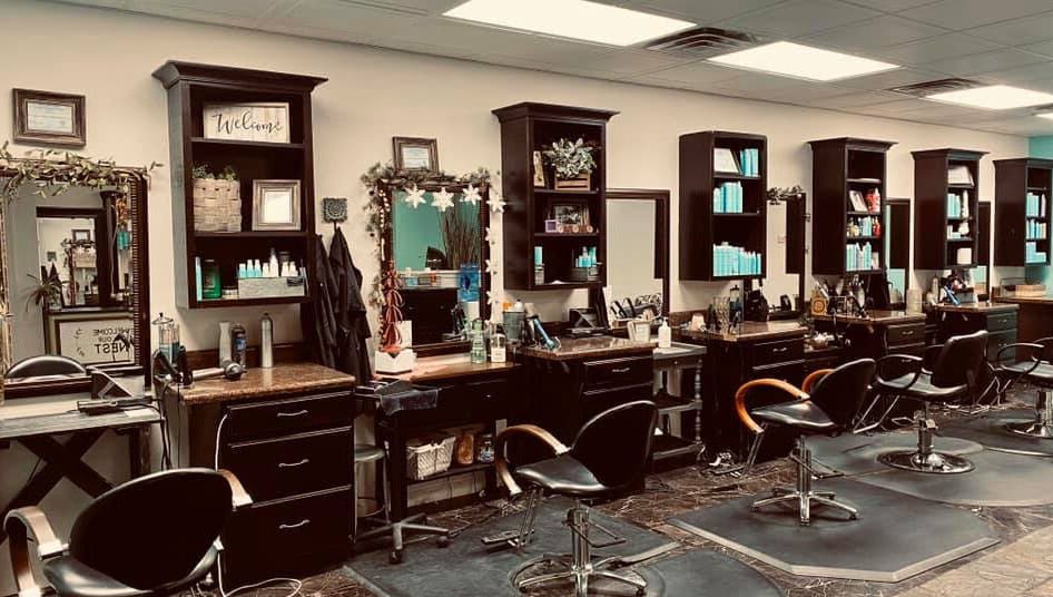 Stylish interior of Rapha Holistic Well Spa, LLC in Clarksville, Tennessee, US showcasing modern salon stations.