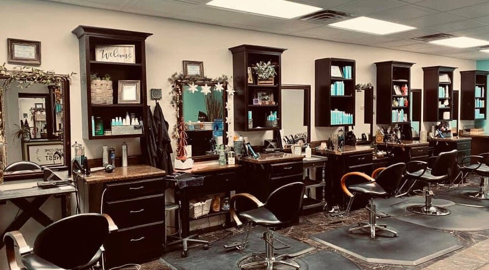 Stylish interior of Rapha Holistic Well Spa, LLC in Clarksville, Tennessee, US showcasing modern salon stations.