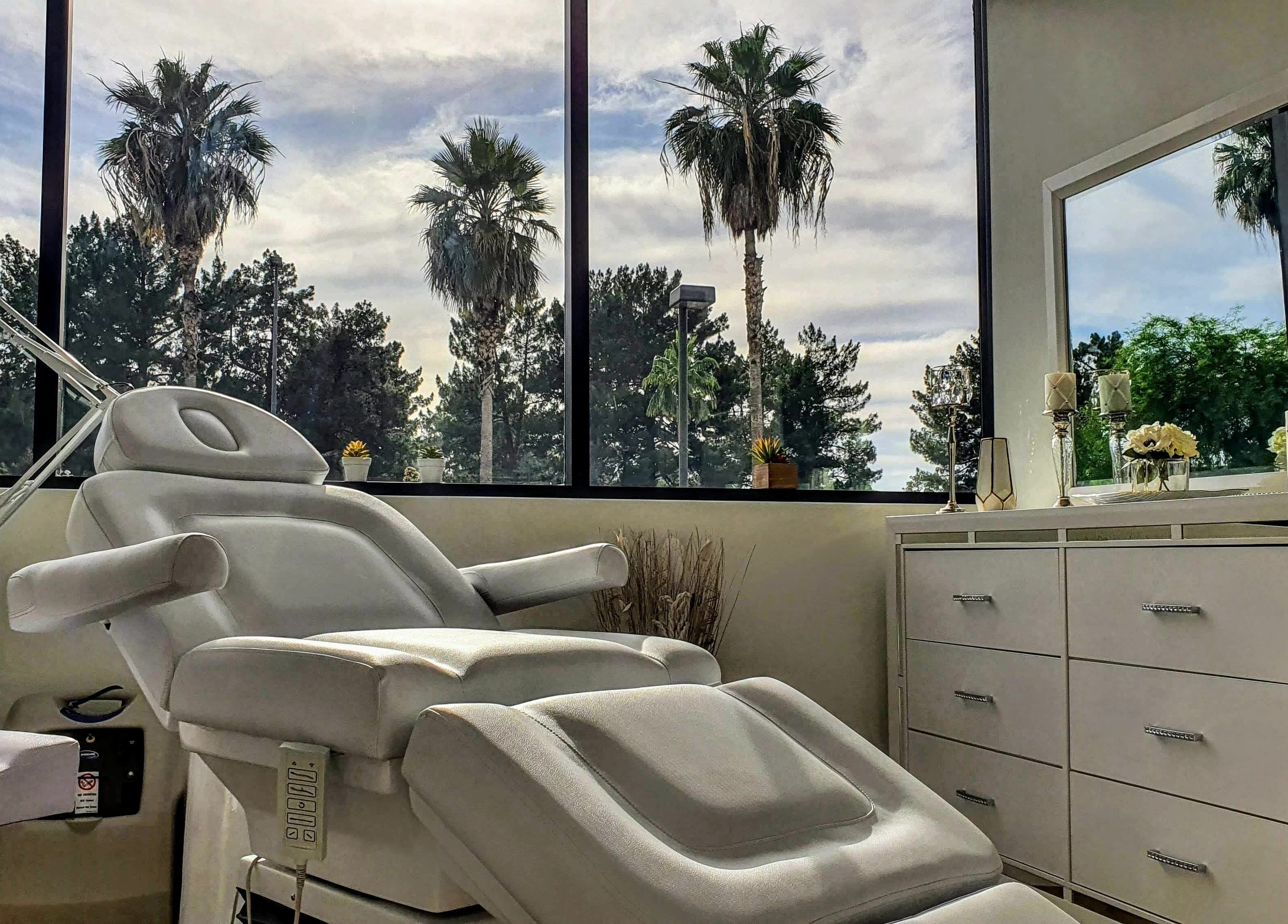 Luxurious treatment room at Euro Glam Gilbert, Gilbert, Arizona, US, featuring a plush white spa chair with scenic views.
