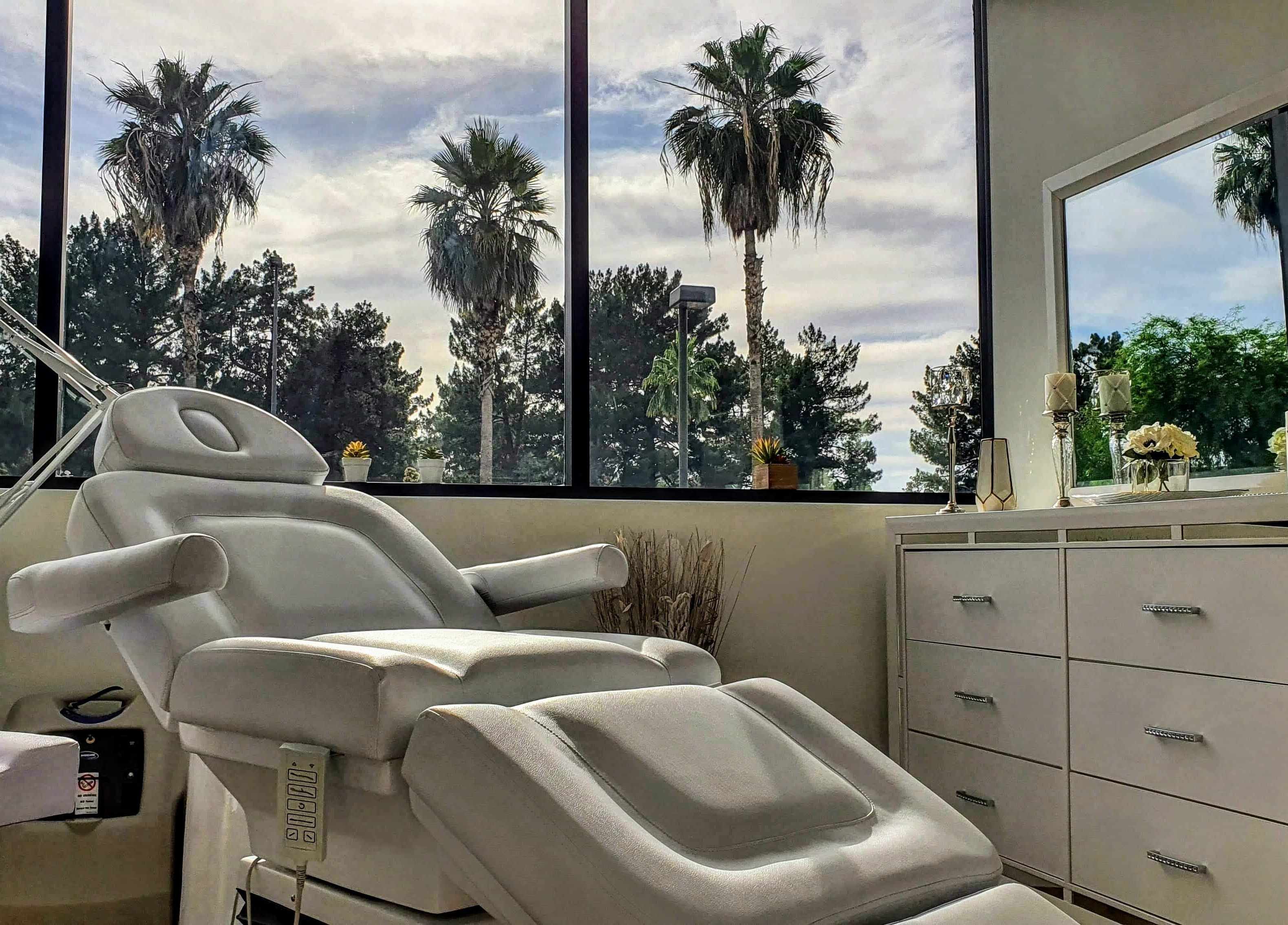 Luxurious treatment room at Euro Glam Gilbert, Gilbert, Arizona, US, featuring a plush white spa chair with scenic views.