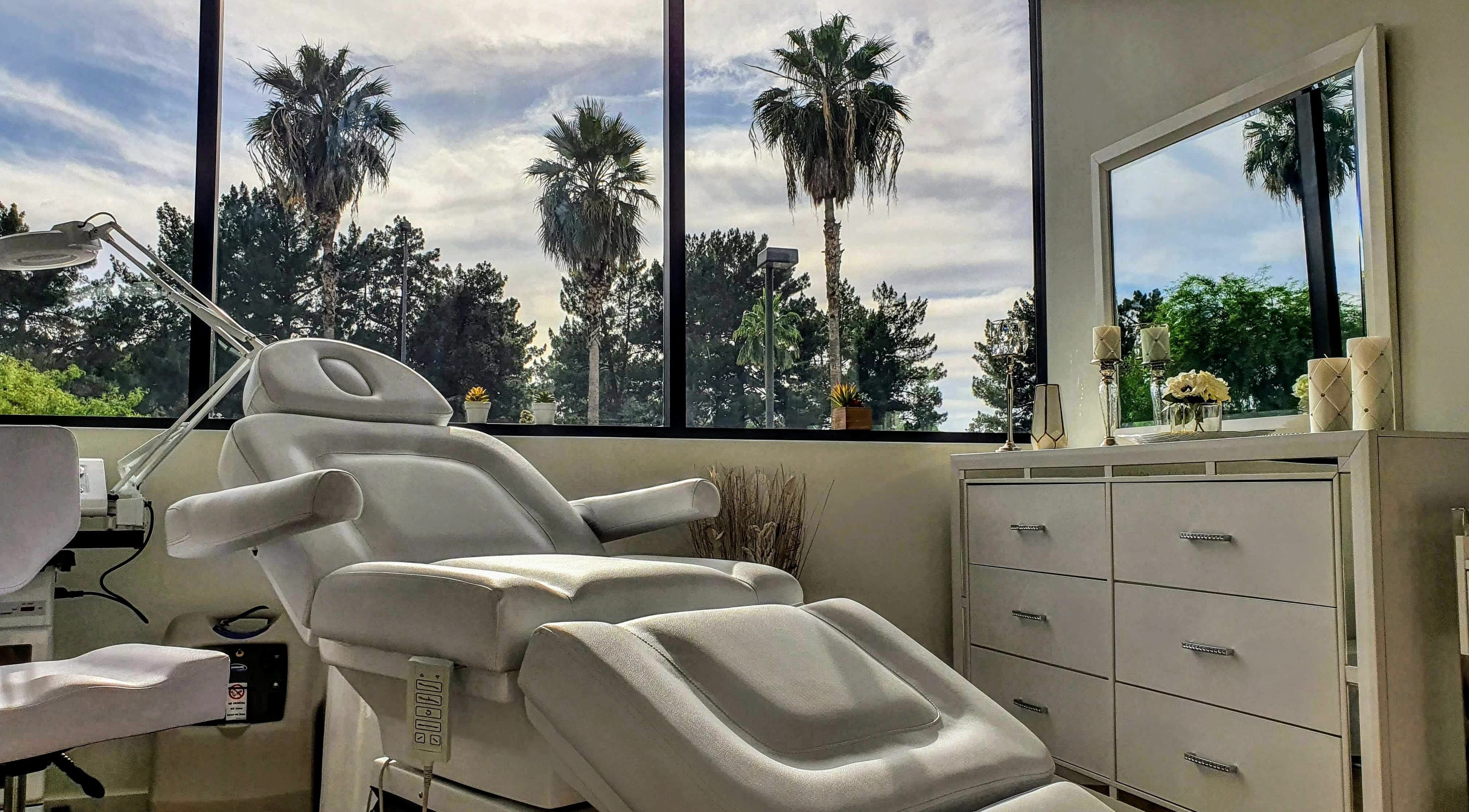 Luxurious treatment room at Euro Glam Gilbert, Gilbert, Arizona, US, featuring a plush white spa chair with scenic views.