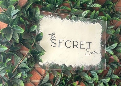 Leafy sign at Misha Greaves Hairstylist, Garstang, England, GB showing 'The Secret Salon'.