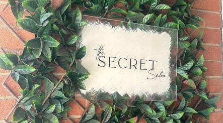 Leafy sign at Misha Greaves Hairstylist, Garstang, England, GB showing 'The Secret Salon'.