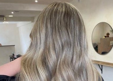 Styled hair in waves at Misha Greaves Hairstylist, Garstang, England, GB. Elegant salon interior.