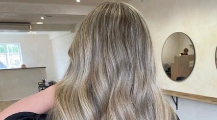 Styled hair in waves at Misha Greaves Hairstylist, Garstang, England, GB. Elegant salon interior.