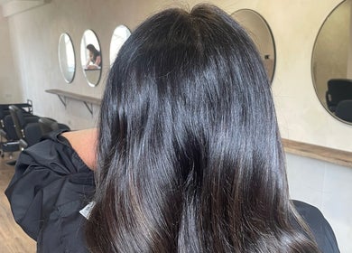 Stylish interior of Misha Greaves Hairstylist in Garstang, England, GB, highlighting sleek hair and modern mirrors.