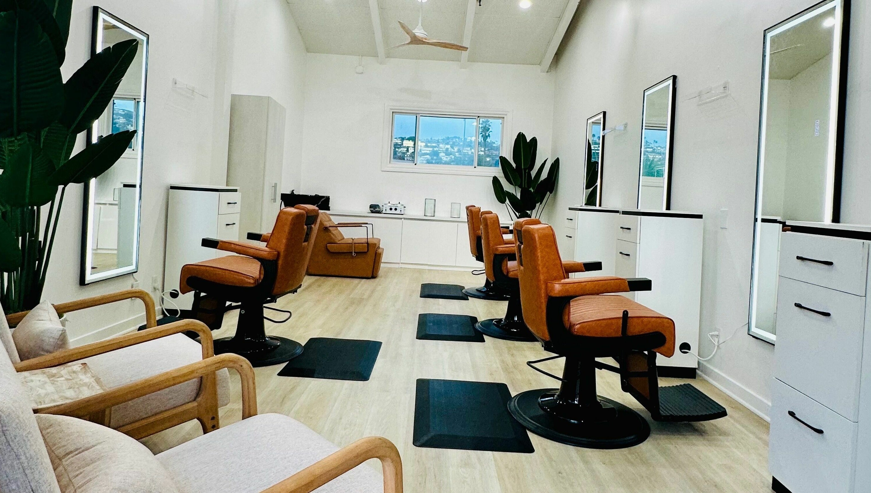 Modern salon interior with sleek chairs at IN STYLE Men’s Salon Laguna Beach & Lake Forest, Laguna Beach, California, US.