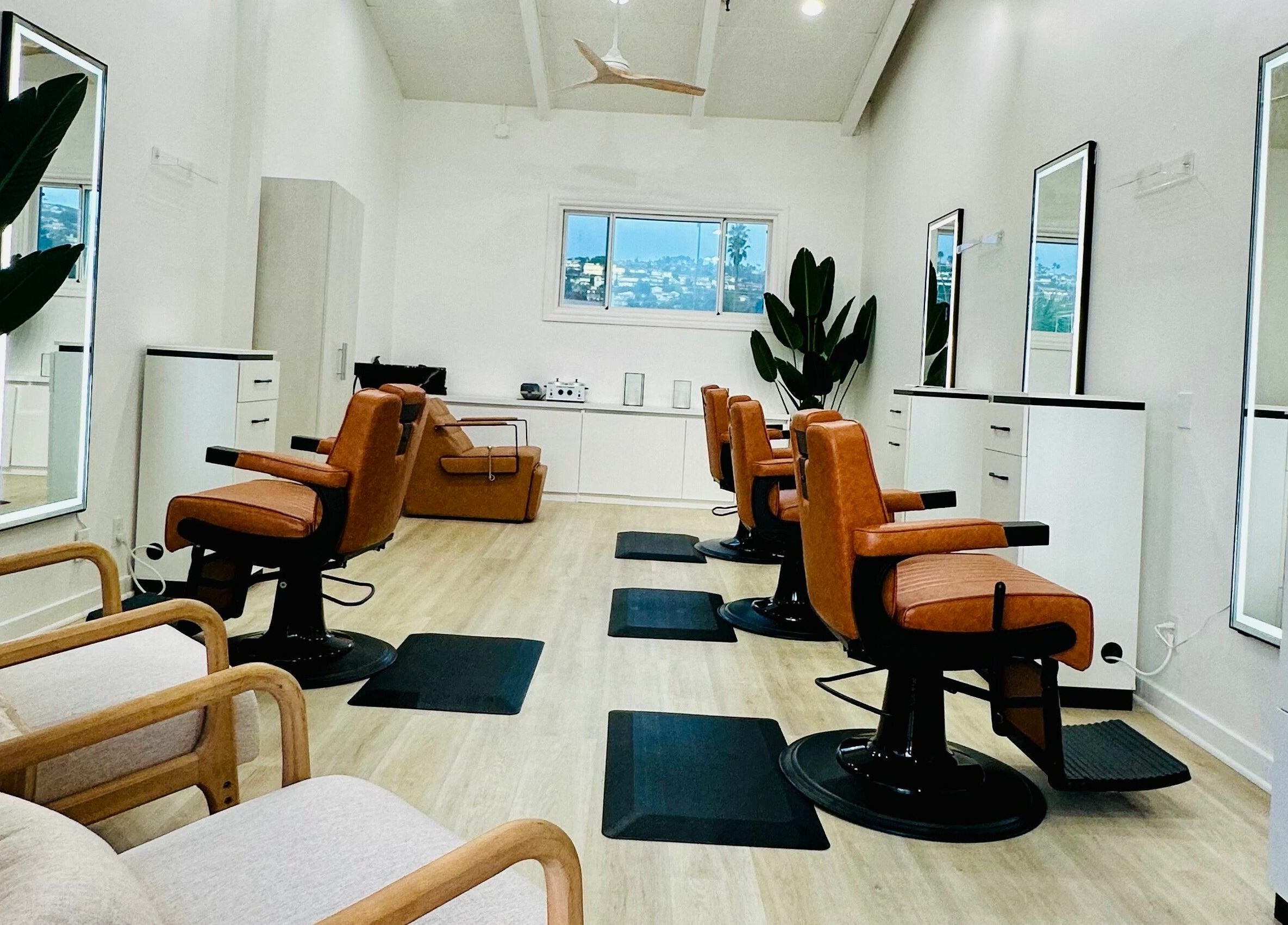 Modern salon interior with sleek chairs at IN STYLE Men’s Salon Laguna Beach & Lake Forest, Laguna Beach, California, US.