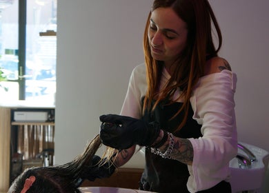 Professional hairstylist at Lil Frenchie Hair, Glebe, New South Wales, AU, providing expert hair treatment.