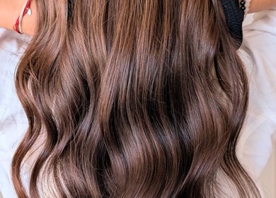 Elegant brown waves styled at Colorbox Hair, Coomera, QLD, AU showcasing professional hairstyling.