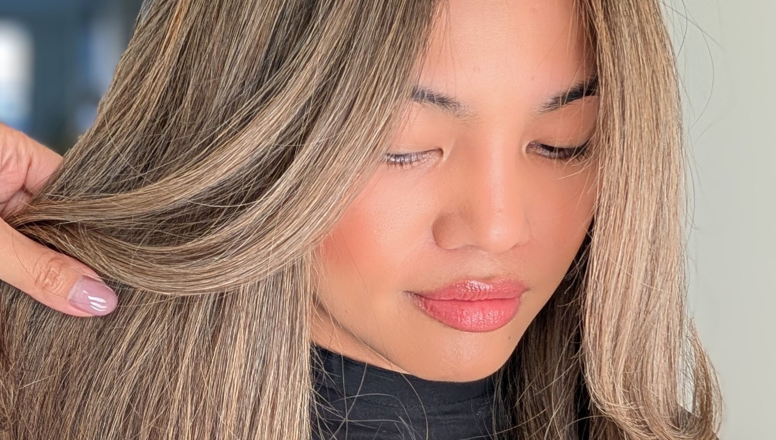 Woman with highlighted hair styled at Colorbox Hair, Coomera, QLD, AU.