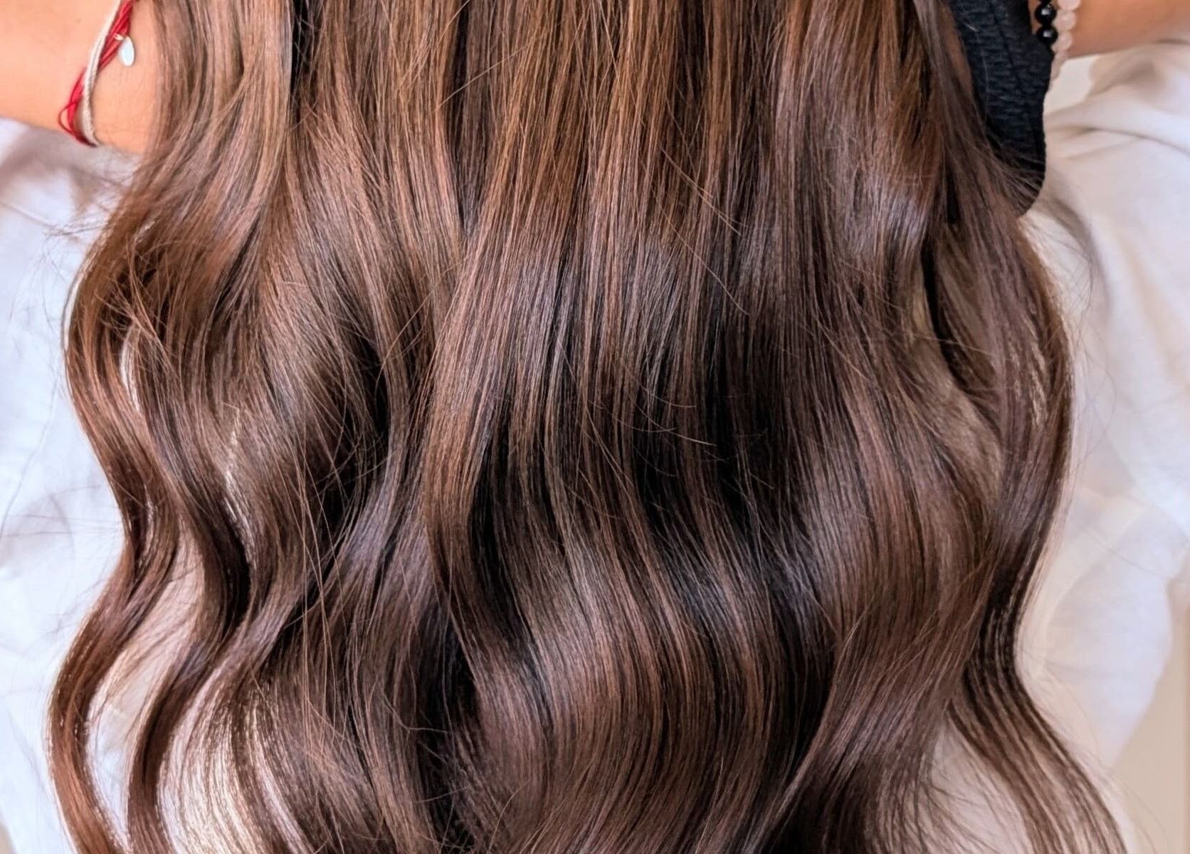 Flowing brown hair styled in waves at Colorbox Hair, Coomera, QLD, AU.