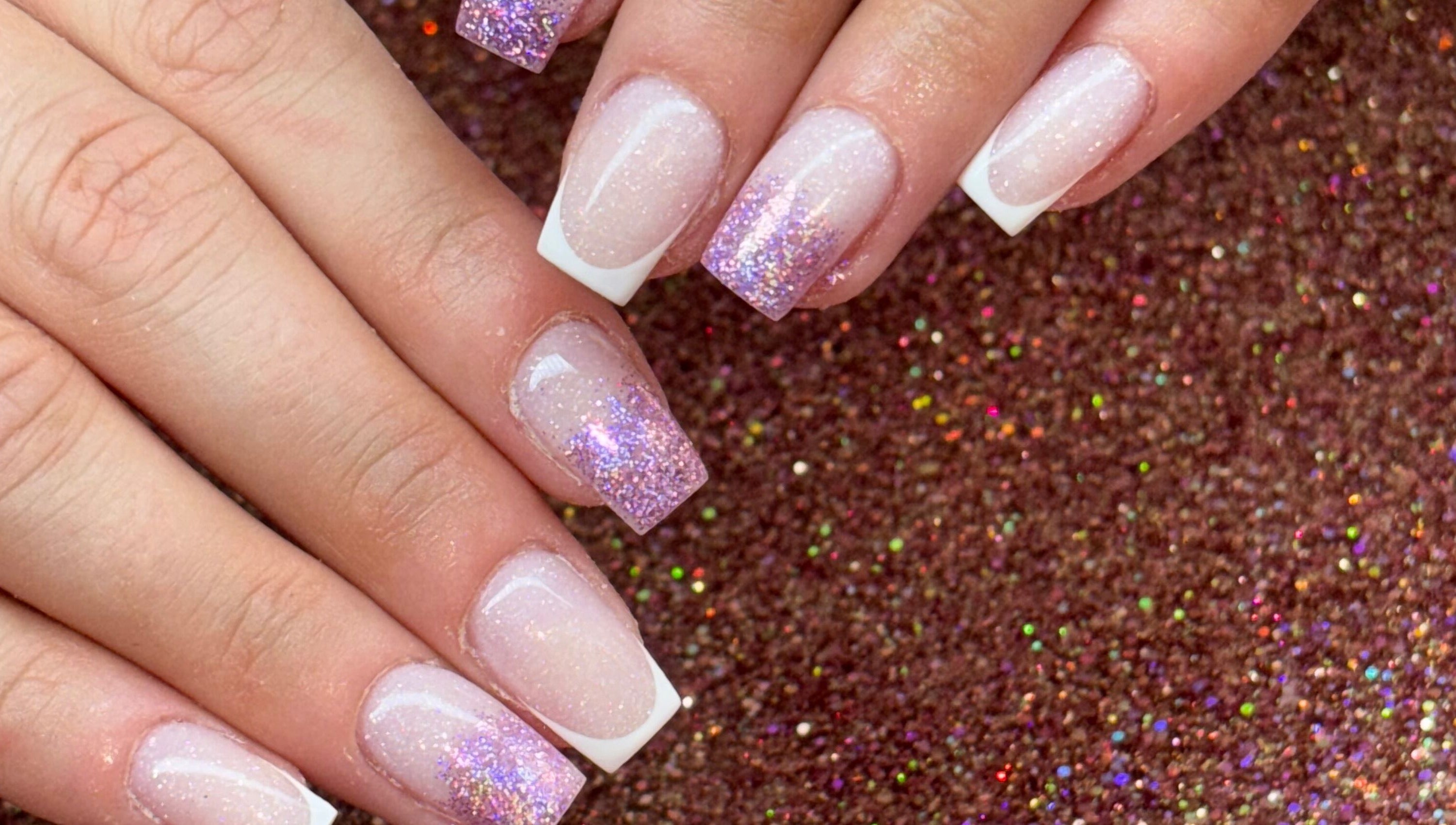 Glittery French manicure at Luxe Beauty MK, Crownhill, England, GB. Perfect for a stylish look.